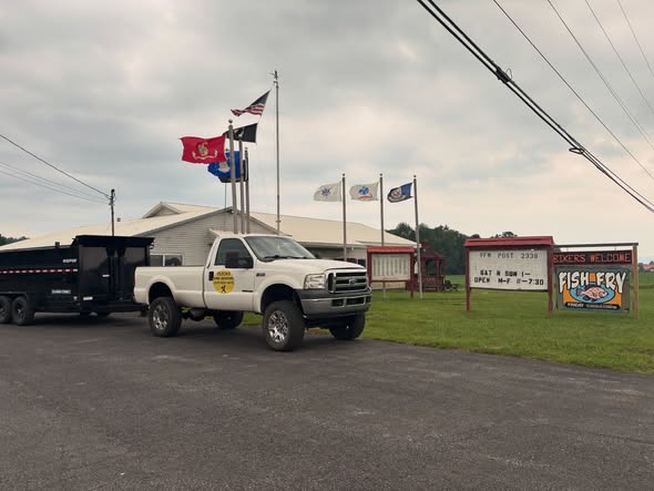 Quick's Junk Removal truck and dump trailer arriving for a pickup
